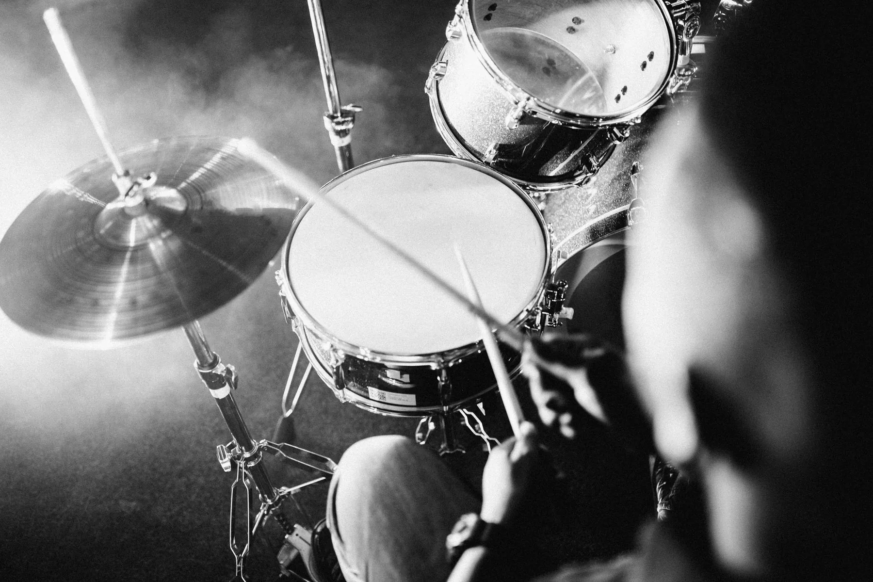 Drummer playing an acoustic drum kit softly