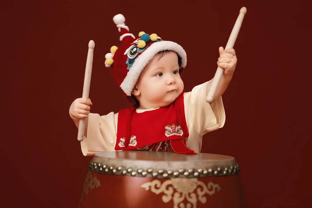 Child playing a traditional drum
