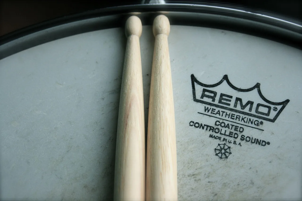 Drumsticks resting on a snare drum