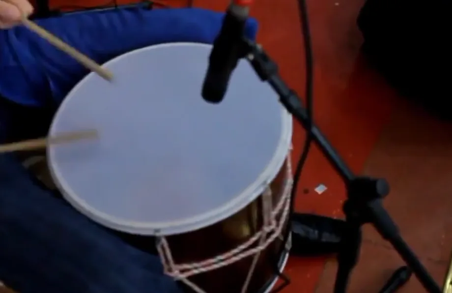Musician playing a drum with drumsticks Musician playing a drum with drumsticks