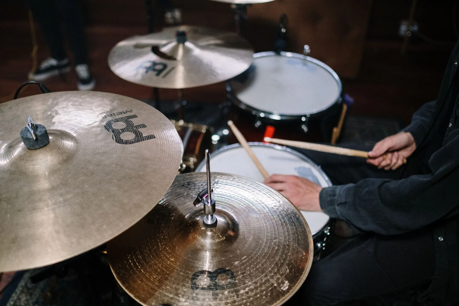 Drummer practicing on an acoustic drum kit Drummer practicing on an acoustic drum kit