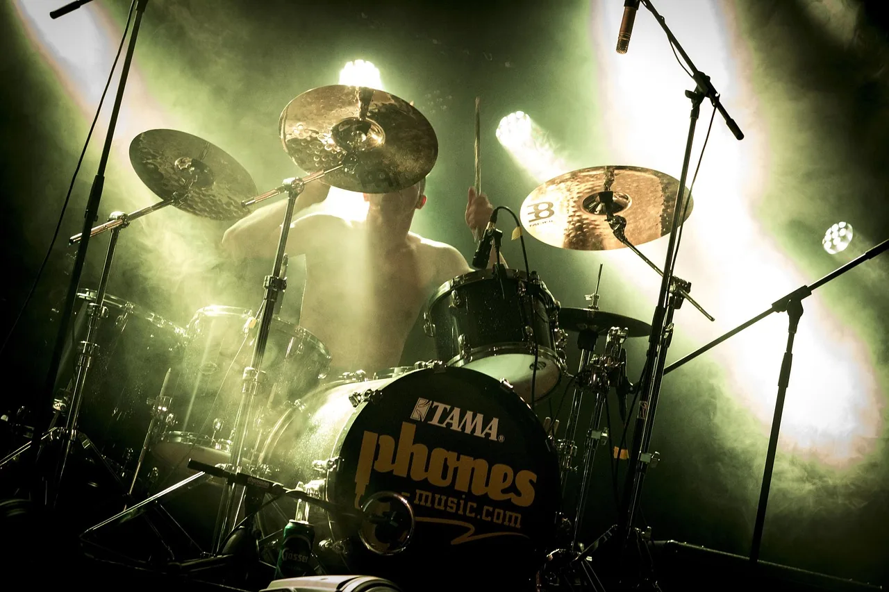 Drummer performing onstage at a concert Drummer performing onstage at a concert