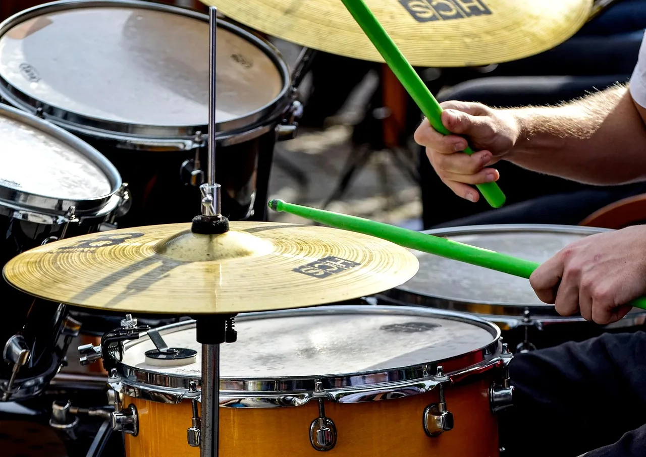 Drummer playing an acoustic drum kit