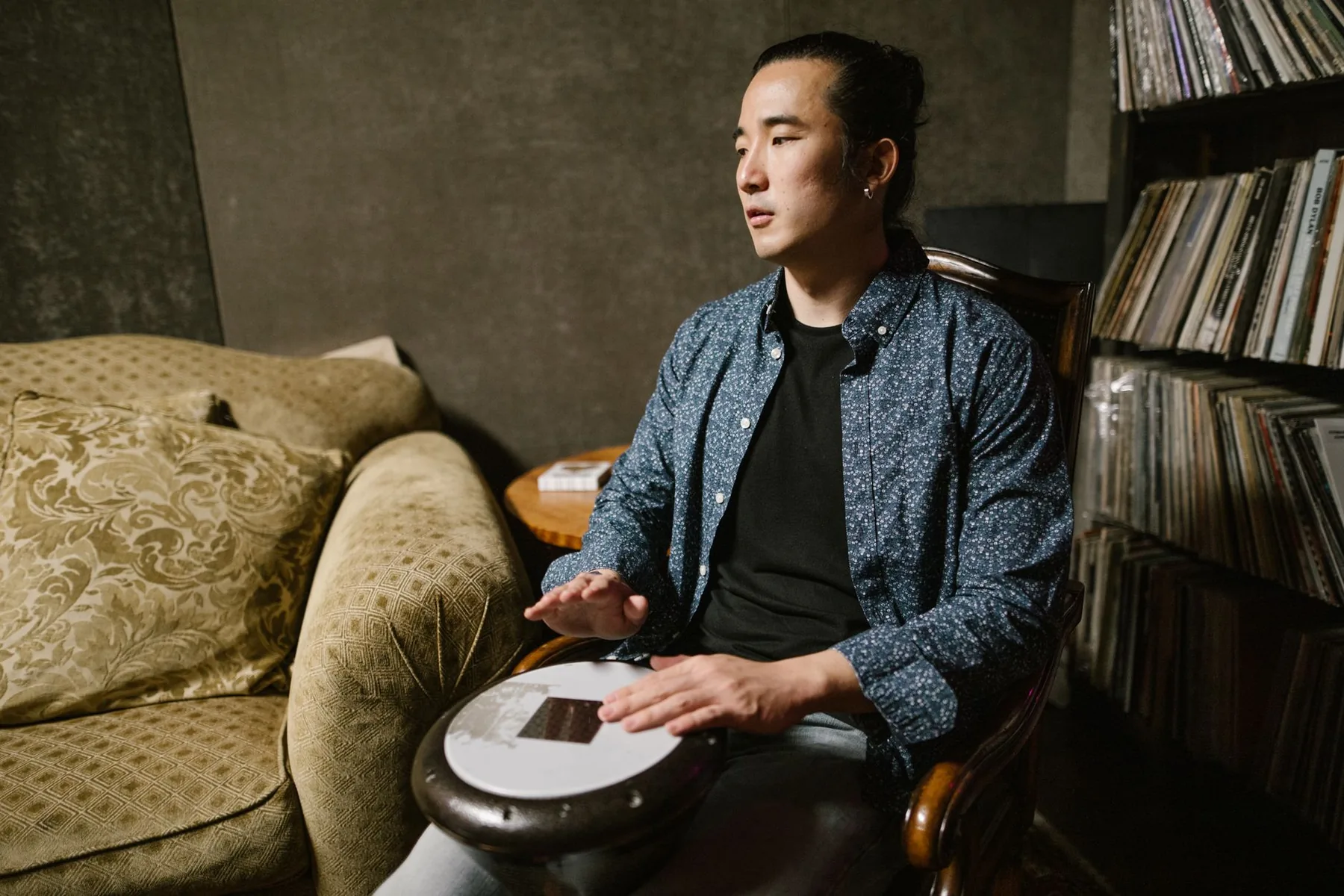 Musician playing a tongue drum in a studio Musician playing a tongue drum in a studio